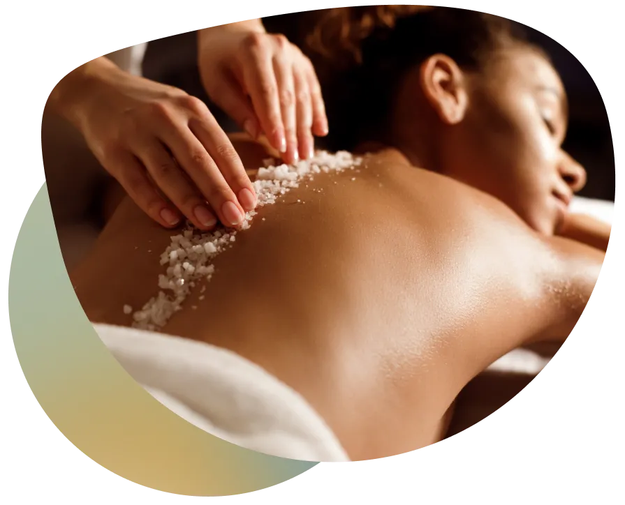 Woman receiving a massage on a massage table with white powder applied to her back.