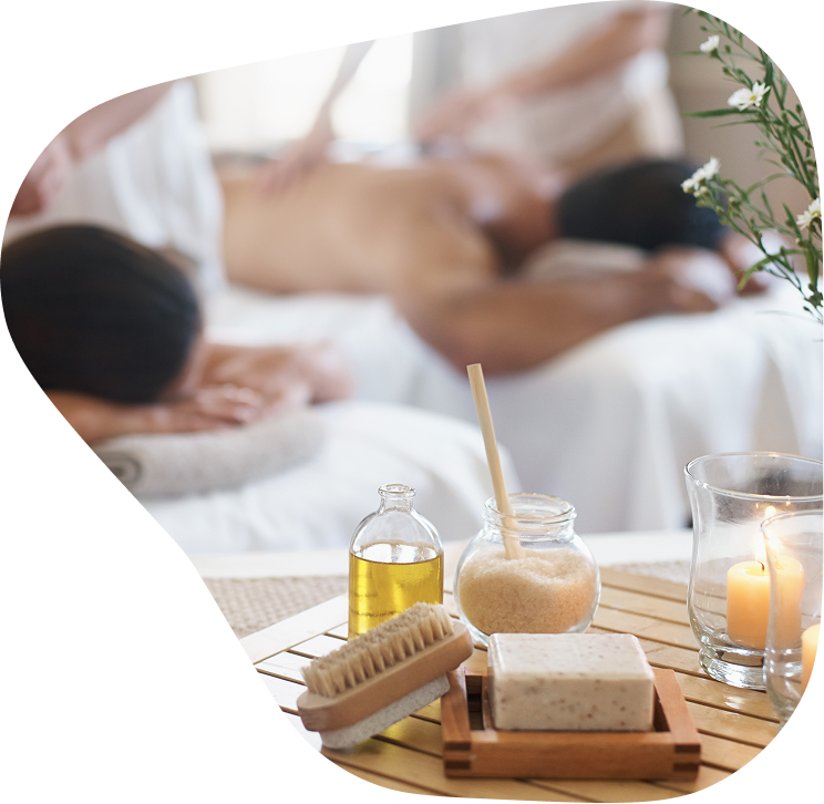 A tranquil spa setting with a wooden tray and massage oil, suggesting a relaxing ambiance for a deep tissue sports massage course.