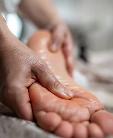 A person massaging a foot in a spa setting.