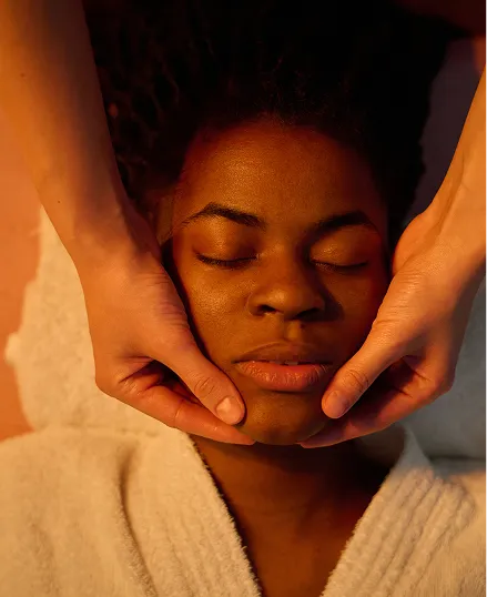 Woman receiving a head and neck massage with a serene atmosphere
