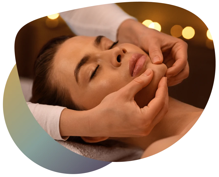 Woman receiving a massage, hands on neck, in a serene spa setting