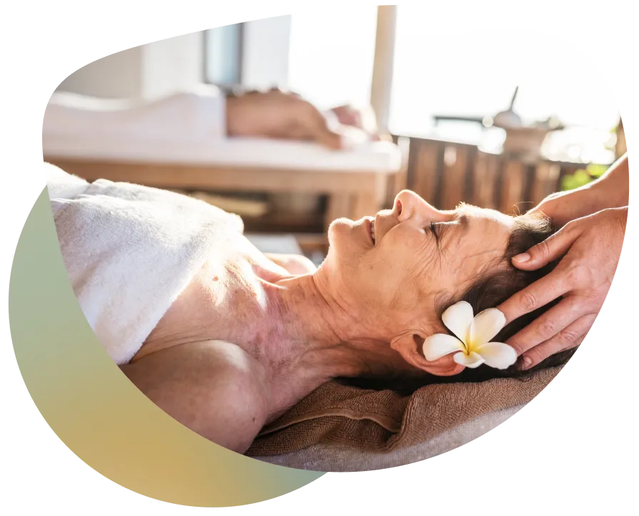 A woman receiving a therapeutic massage in a serene and relaxing environment, with a focus on natural and holistic wellness practices.