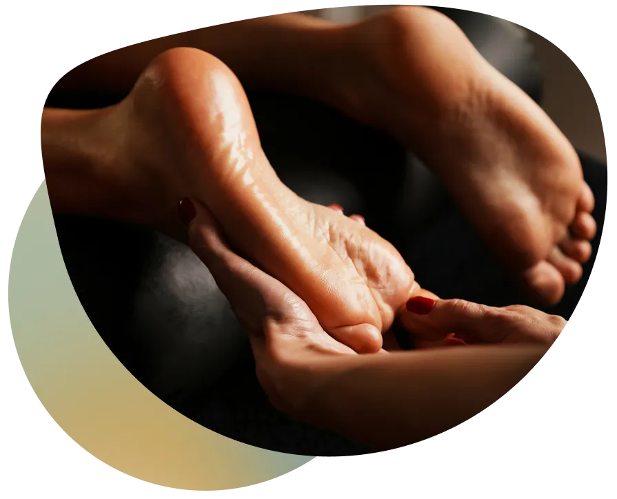 Close-up of a person's relaxed foot with red nail polish, resting on a black surface.