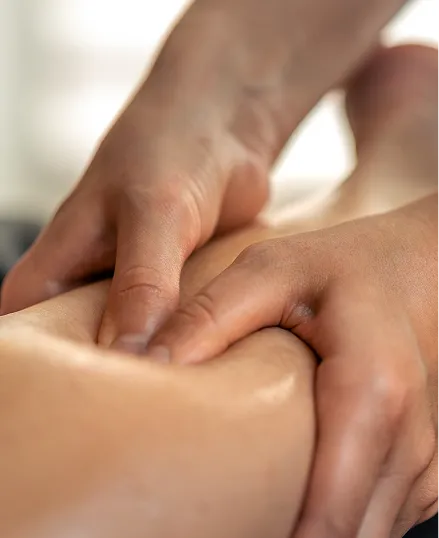 A person receiving a massage on their back, with a gentle touch, in a calm environment.