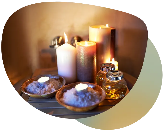A serene table setting with candles and a bowl of white powder, creating a tranquil atmosphere.