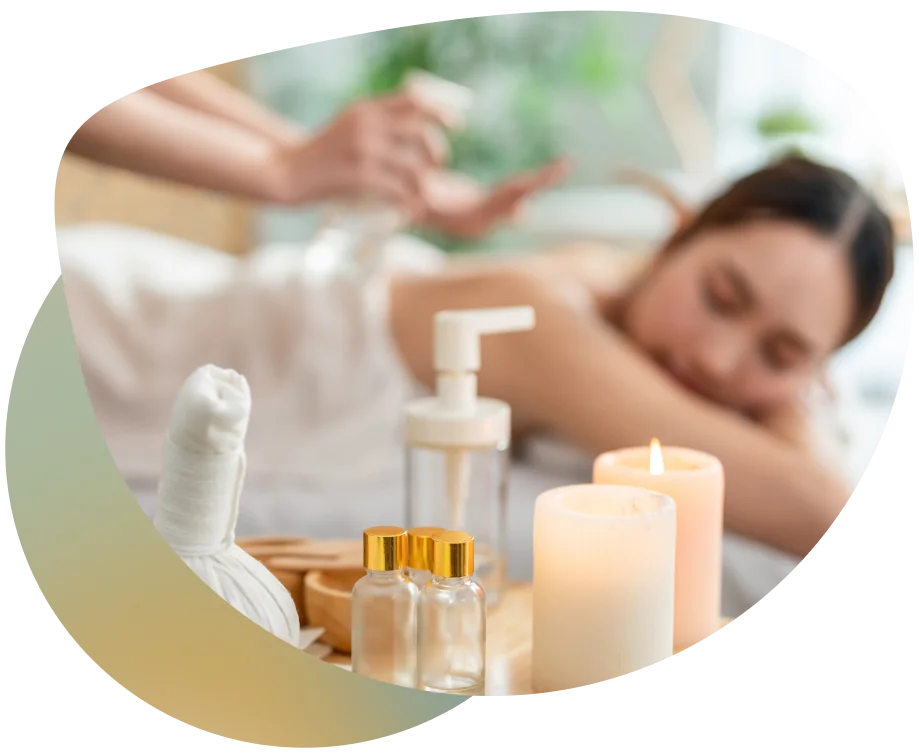 Woman relaxing on a bed with spa essentials and a calming candle